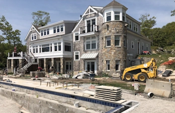 Backyard landscaping with swimming pool and natural stone patio in Gloucester, Massachusetts
