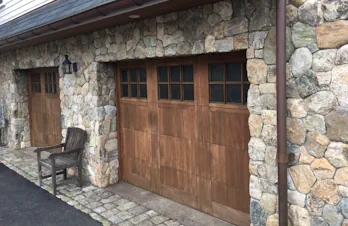 Natural stone veneer surrounding garage doors on a home in Groton, Massachusetts