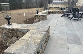 Custom natural stone veneer siding and retaining wall accents completed by S. Phaneuf & Associates in Massachusetts.