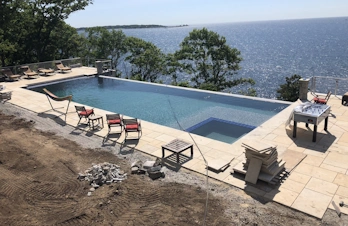 Custom natural stone pool deck and outdoor living space constructed by S. Phaneuf & Associates in Massachusetts.