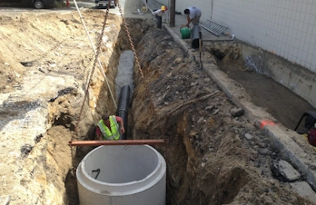 Main line sewer trench excavation and utility installation in Concord, Massachusetts
