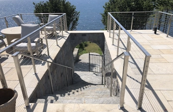 Custom natural stone steps and arched stairway constructed by S. Phaneuf & Associates in Massachusetts.