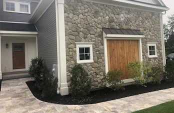 Exterior stone accent wall installed on a custom home in Groton, Massachusetts